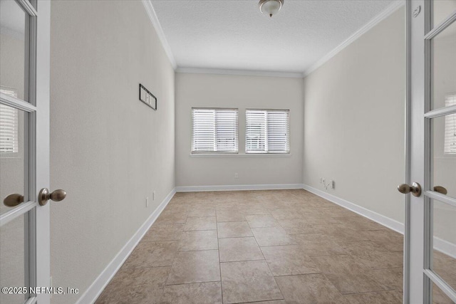 spare room with a textured ceiling, crown molding, and french doors