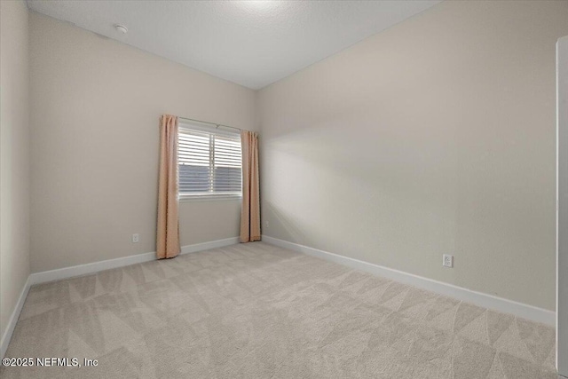 empty room featuring light colored carpet