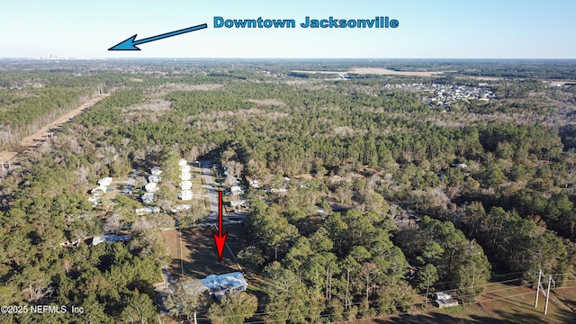 birds eye view of property with a view of trees