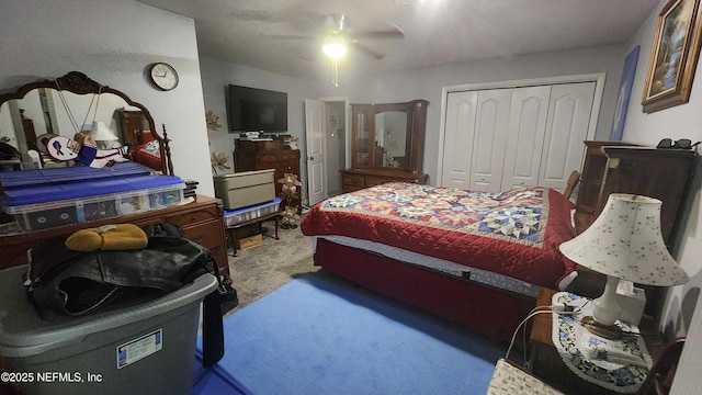 carpeted bedroom featuring ceiling fan and a closet