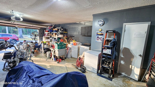 garage featuring washer and dryer, a garage door opener, and fridge