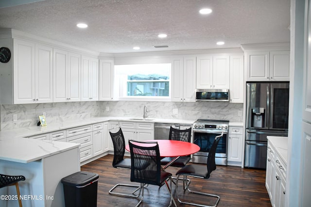 kitchen featuring white cabinets, stainless steel appliances, and sink