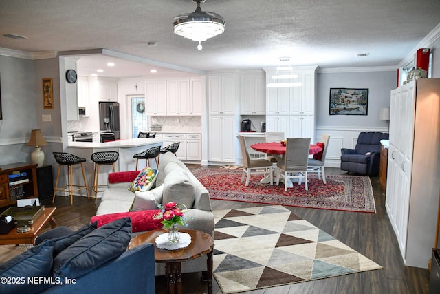 living area with dark wood finished floors, crown molding, and a textured ceiling