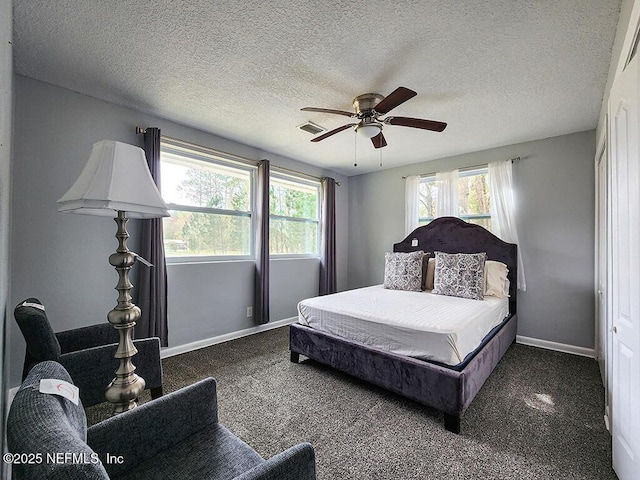 bedroom with multiple windows, baseboards, visible vents, and ceiling fan