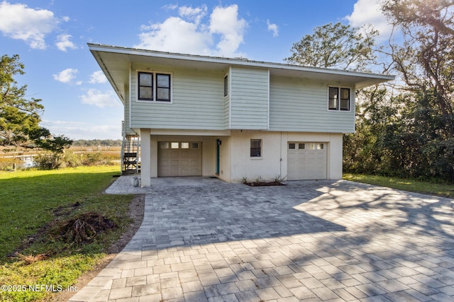 view of front facade with a front yard and a garage