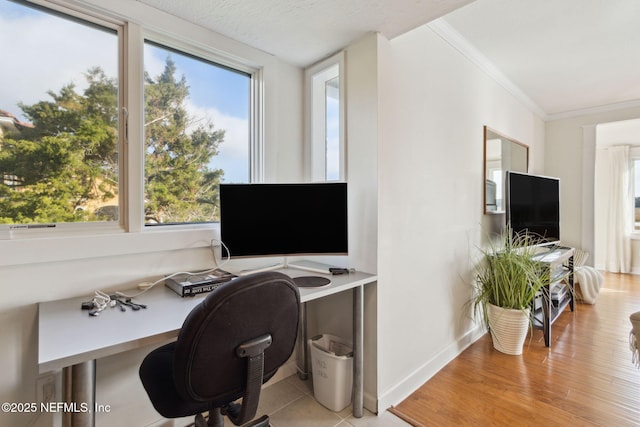 tiled home office featuring ornamental molding and a wealth of natural light