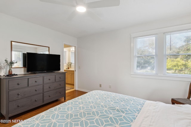 bedroom featuring ensuite bathroom, dark hardwood / wood-style flooring, and ceiling fan