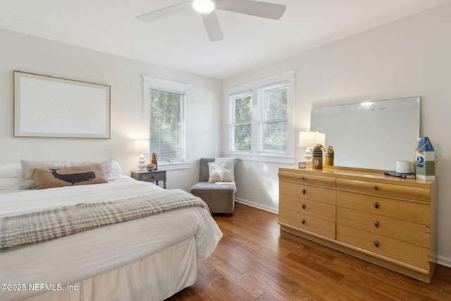 bedroom with ceiling fan and dark hardwood / wood-style flooring