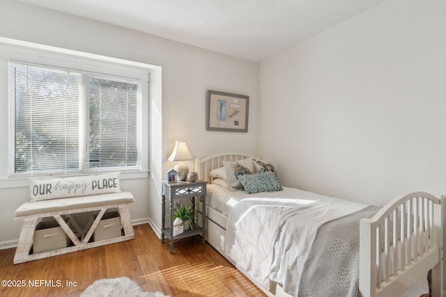 bedroom with hardwood / wood-style floors