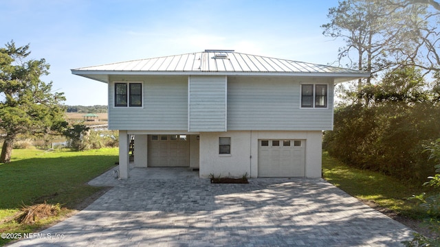 exterior space with a yard and a garage