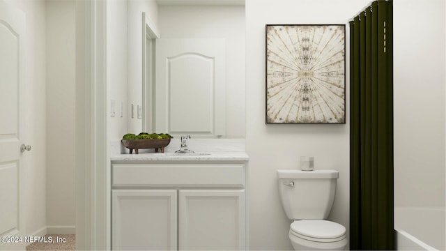 bathroom featuring vanity, toilet, and a tub