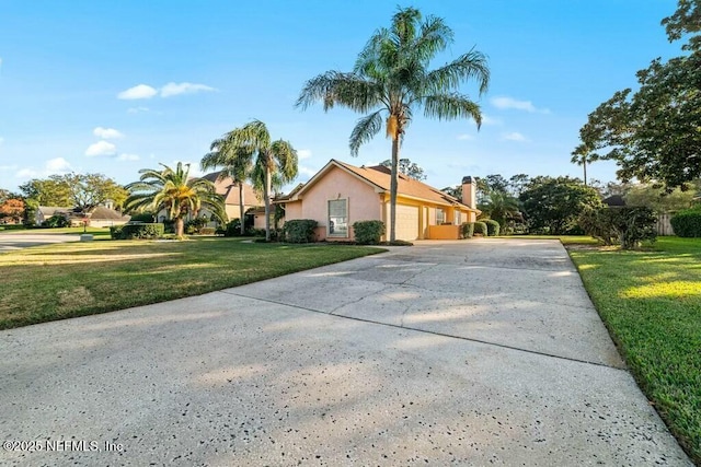 view of front of home featuring a garage and a front lawn