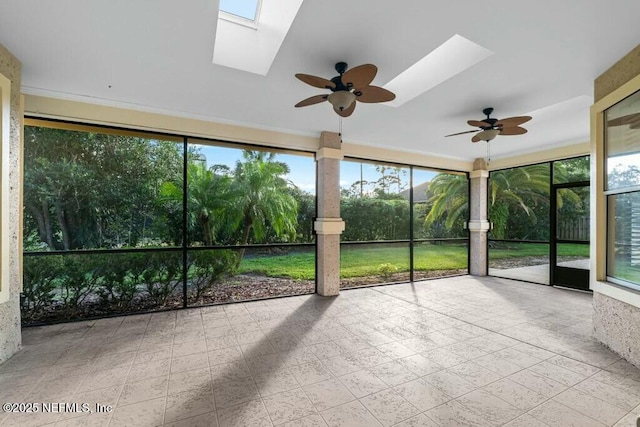 unfurnished sunroom with a skylight and ceiling fan