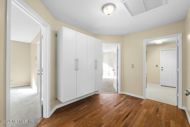 unfurnished bedroom featuring a closet and wood-type flooring