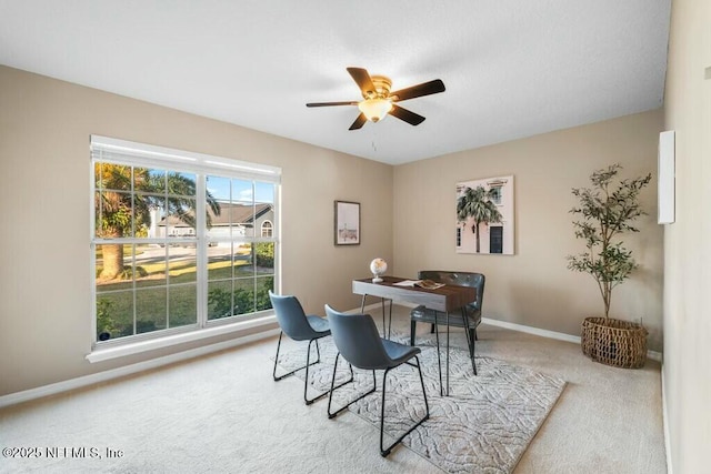 carpeted dining room featuring a wealth of natural light and ceiling fan