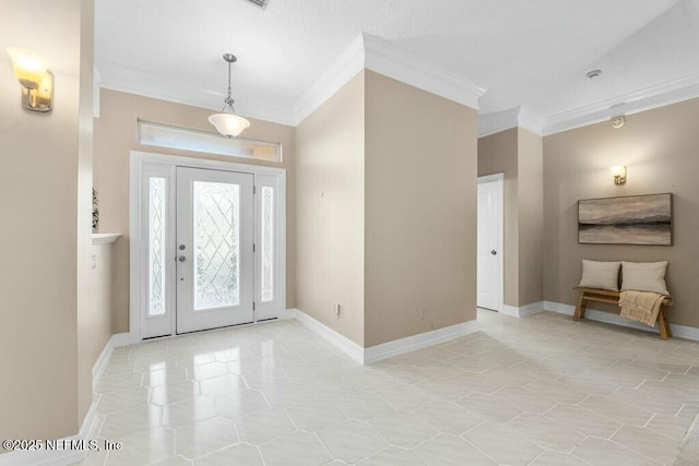 tiled entrance foyer featuring crown molding