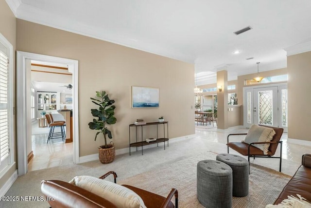 carpeted living room featuring ceiling fan and crown molding