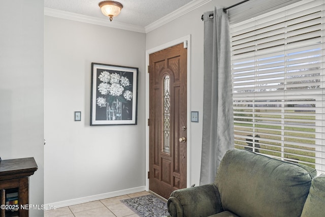 tiled foyer entrance with a textured ceiling and ornamental molding