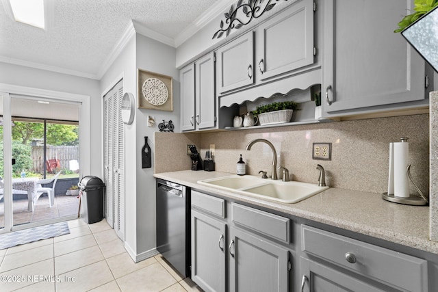 kitchen featuring backsplash, dishwasher, light tile patterned floors, and sink