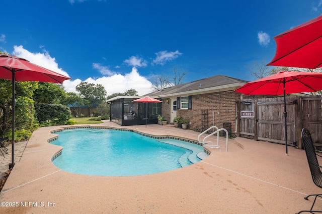 view of pool featuring a patio area and a sunroom