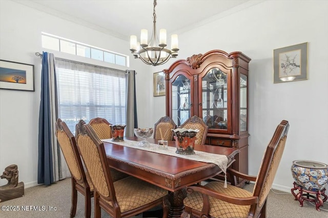 carpeted dining room featuring an inviting chandelier and crown molding