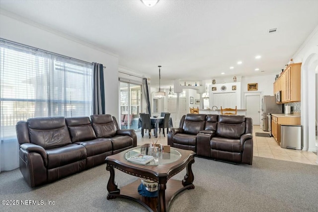 living room featuring ornamental molding and light tile patterned floors