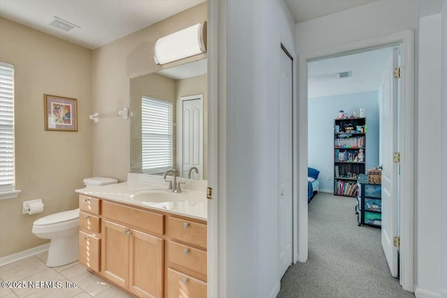 bathroom featuring tile patterned floors, vanity, and toilet