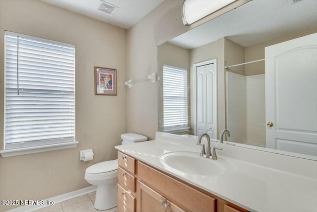 bathroom featuring tile patterned flooring, vanity, and toilet