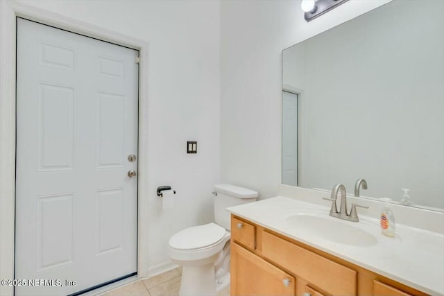 bathroom with tile patterned floors, vanity, and toilet