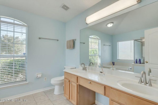 bathroom with toilet, tile patterned flooring, vanity, and a washtub