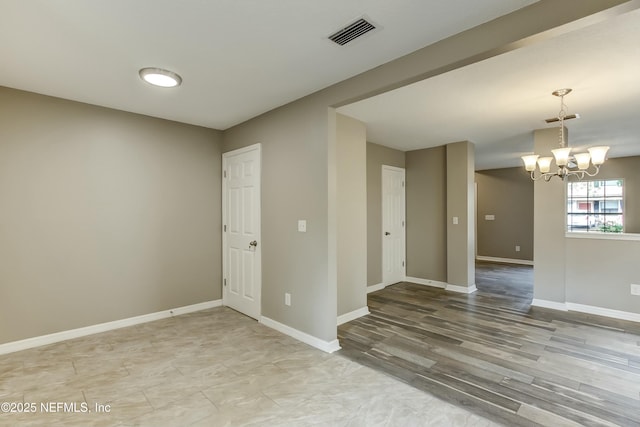 spare room with a chandelier