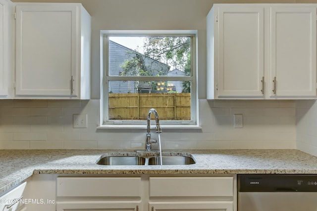 kitchen with white cabinets, stainless steel dishwasher, and sink