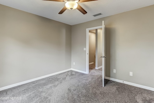 carpeted spare room featuring ceiling fan