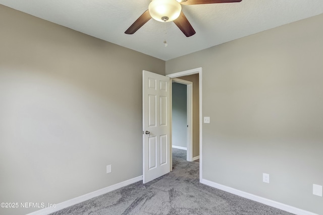 empty room with light colored carpet and ceiling fan