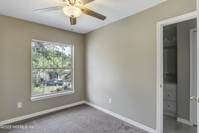 carpeted empty room with ceiling fan