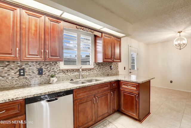 kitchen featuring light stone countertops, stainless steel dishwasher, sink, decorative light fixtures, and a chandelier