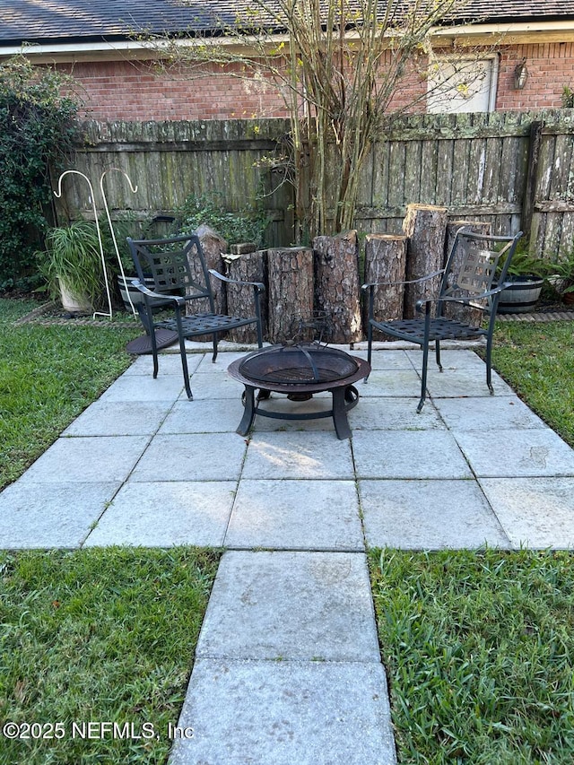 view of patio / terrace featuring an outdoor fire pit