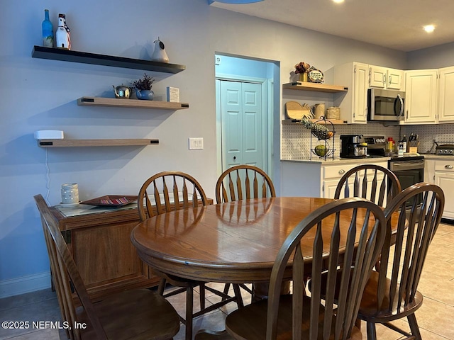 dining area featuring light tile patterned floors