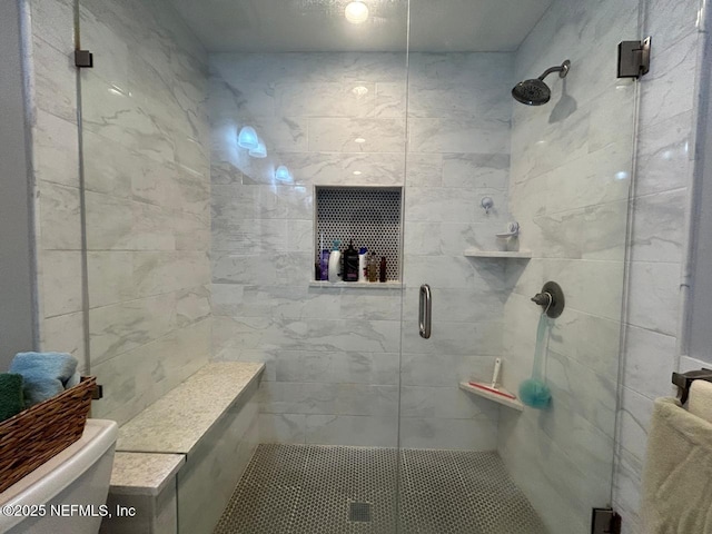 bathroom featuring toilet and an enclosed shower