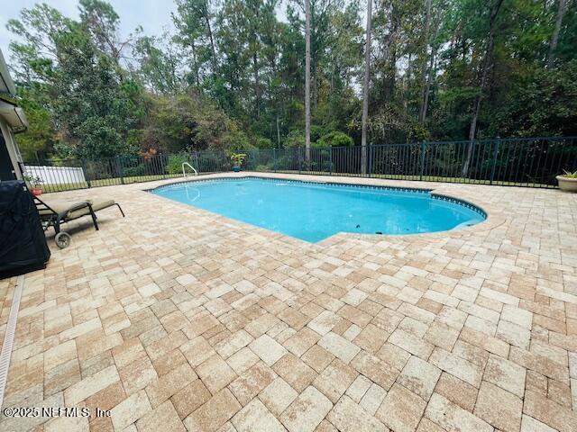 view of swimming pool featuring a patio area