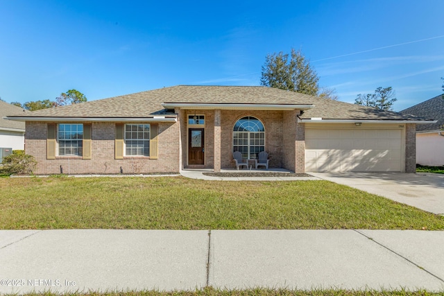 view of front of home with a front yard and a garage