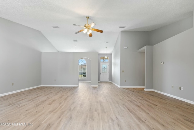 unfurnished living room featuring ceiling fan, high vaulted ceiling, light hardwood / wood-style floors, and a textured ceiling