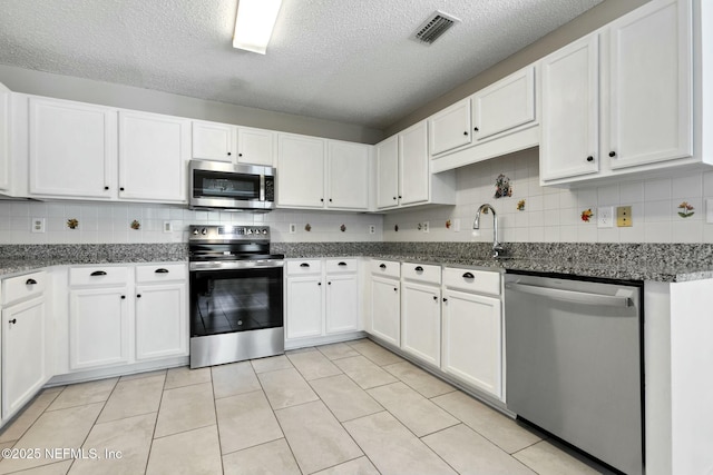 kitchen featuring white cabinets and stainless steel appliances