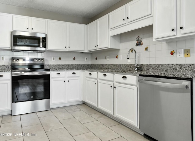 kitchen with appliances with stainless steel finishes and white cabinetry