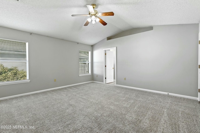 unfurnished room featuring ceiling fan, lofted ceiling, light carpet, and a wealth of natural light