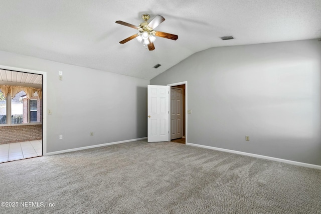 unfurnished bedroom featuring ceiling fan, light carpet, and vaulted ceiling