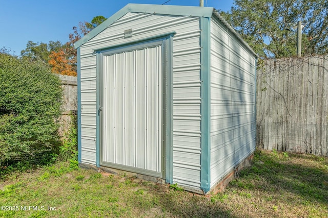 view of outbuilding featuring a yard