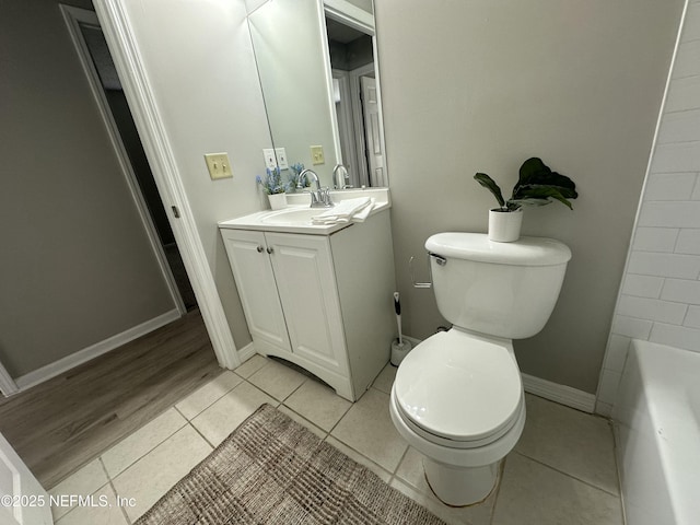 bathroom with tile patterned flooring, vanity, and toilet