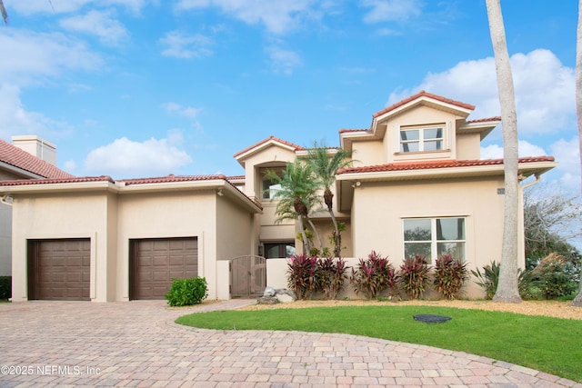 mediterranean / spanish-style home featuring a garage