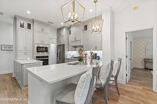 1669 Linkside Ct N, Atlantic Beach, FL 32233 - kitchen with appliances with stainless steel finishes, a chandelier, gray cabinetry, baseboards, and crown molding